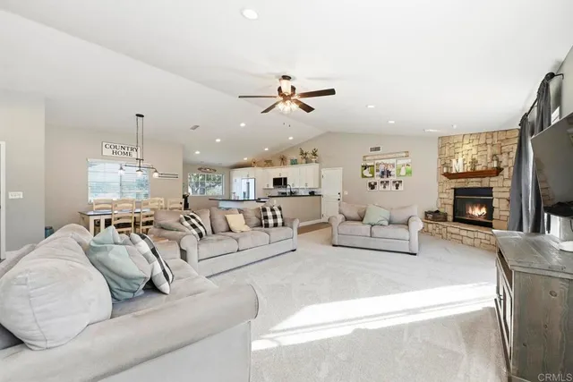 a living room with furniture chandelier and fireplace