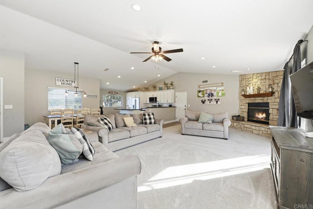 a living room with furniture chandelier and fireplace