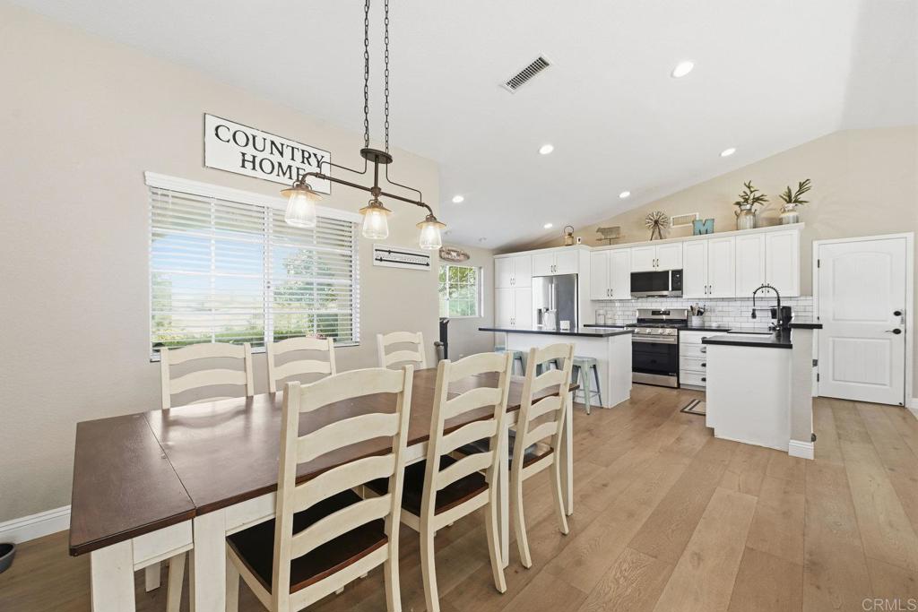 13638 West Oak Glen Road Valley Center, CA 92082 - Photo 13 of 30 a view of a dining room with furniture and wooden floor