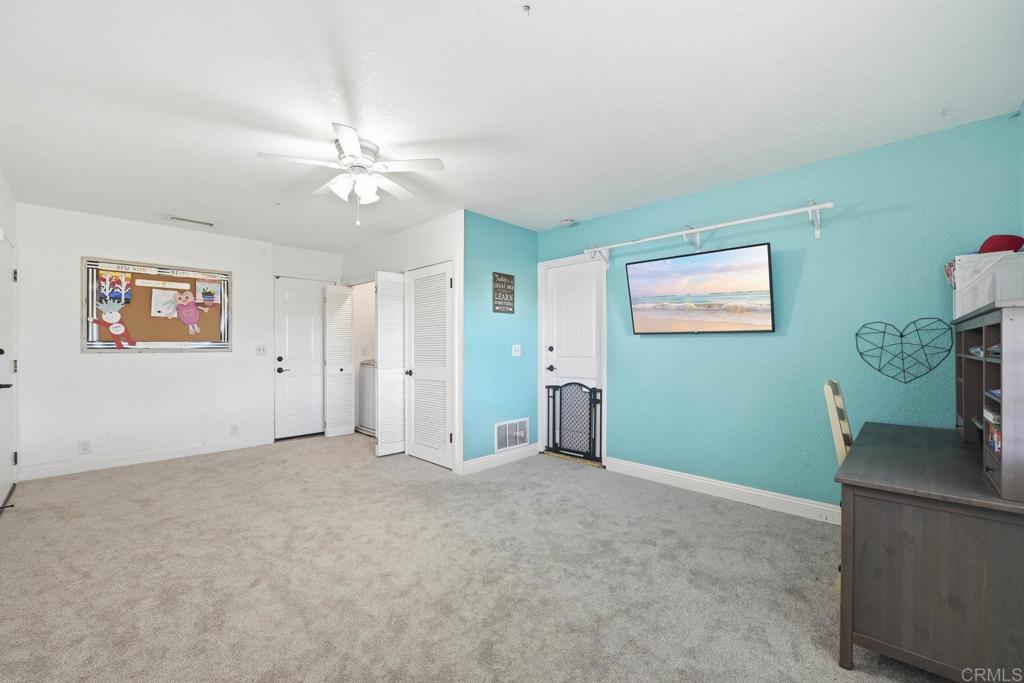 13638 West Oak Glen Road Valley Center, CA 92082 - Photo 15 of 30 an empty room with fan and windows