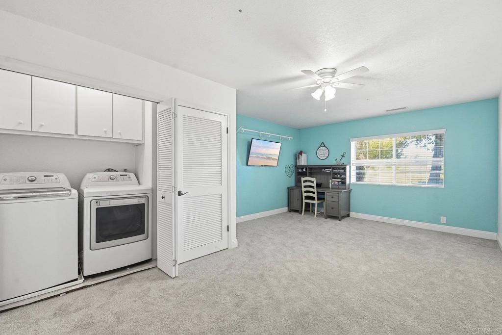 13638 West Oak Glen Road Valley Center, CA 92082 - Photo 16 of 30 a view of a kitchen with fridge and a workspace