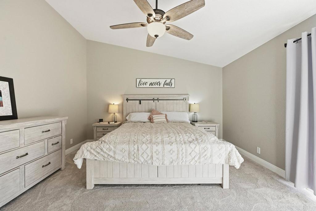 13638 West Oak Glen Road Valley Center, CA 92082 - Photo 17 of 30 a bedroom with a bed and a chandelier