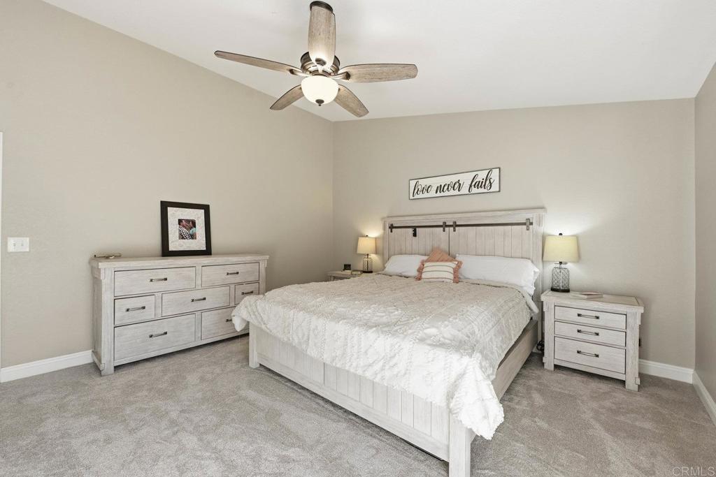 13638 West Oak Glen Road Valley Center, CA 92082 - Photo 18 of 30 a bedroom with a bed and a chandelier