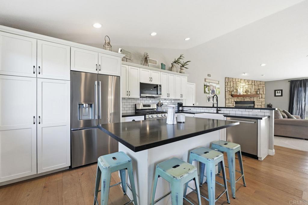 13638 West Oak Glen Road Valley Center, CA 92082 - Photo 3 of 30 a kitchen with stainless steel appliances granite countertop a refrigerator a stove and a sink