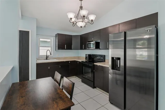 a kitchen with kitchen island a counter top space stainless steel appliances and cabinets
