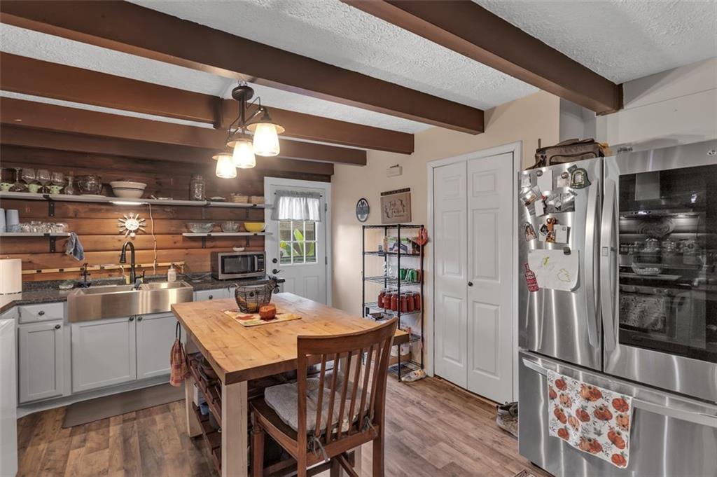 1270 Old State Road Apollo, PA 15613 - Photo 21 of 36 a kitchen with stainless steel appliances a dining table chairs and refrigerator