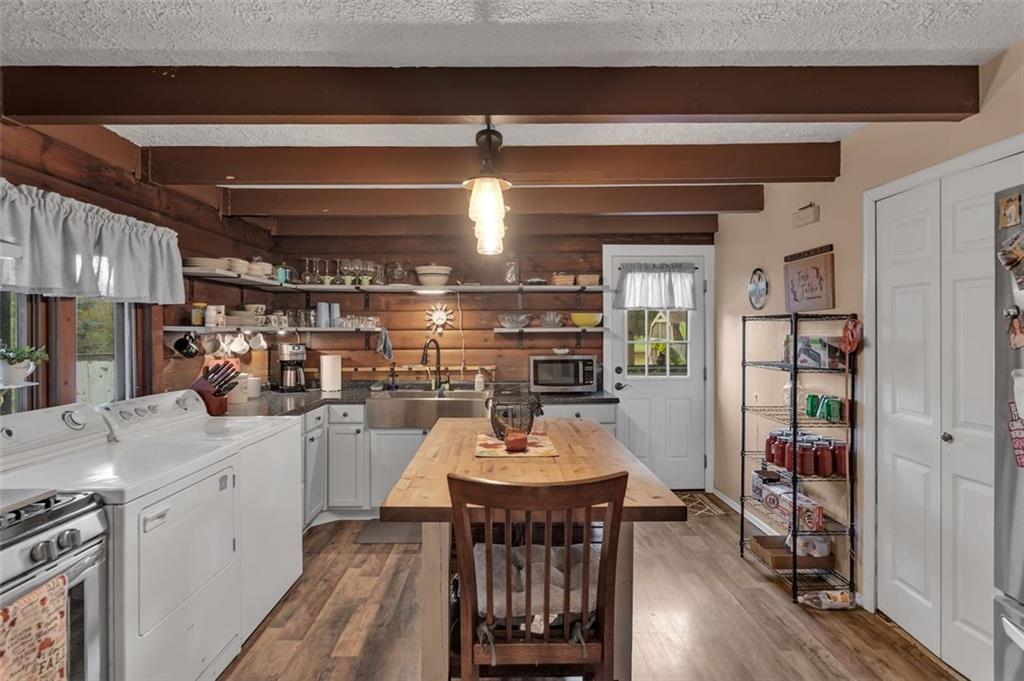 1270 Old State Road Apollo, PA 15613 - Photo 22 of 36 a kitchen with a dining table chairs and refrigerator