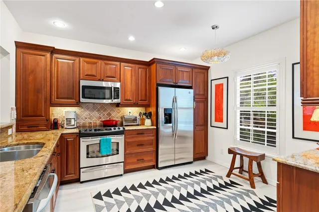 a kitchen with stainless steel appliances granite countertop a stove top oven a sink and dishwasher