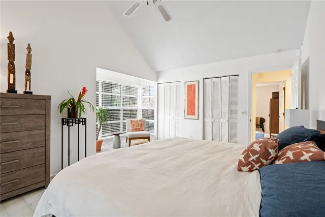 a bedroom with a bed and a large window