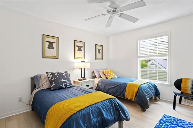 a bedroom with two beds and a window