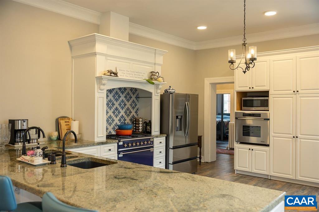 409 Park Street Charlottesville, VA 22902 - Photo 15 of 58 a kitchen with stainless steel appliances kitchen island granite countertop a refrigerator and a sink