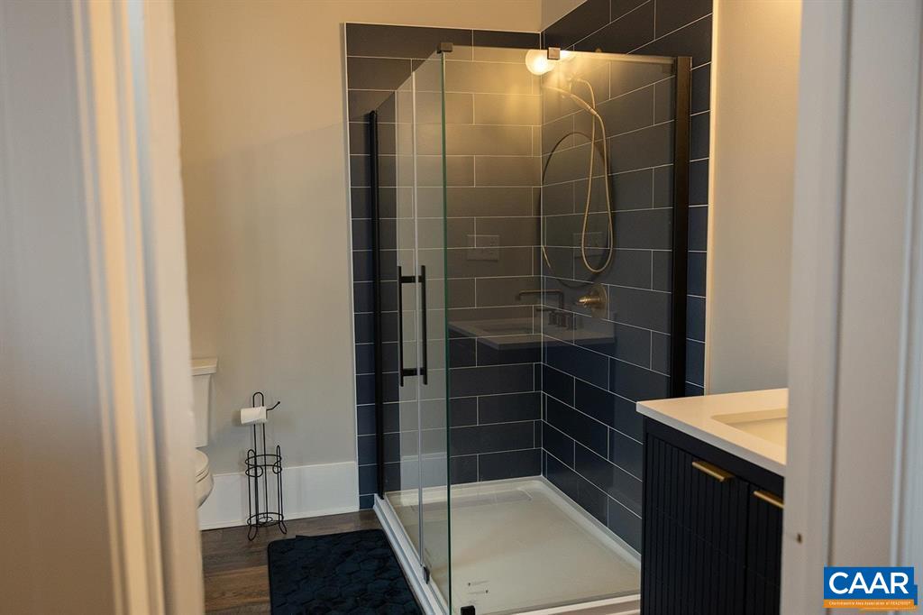 409 Park Street Charlottesville, VA 22902 - Photo 20 of 58 a bathroom with a glass shower door