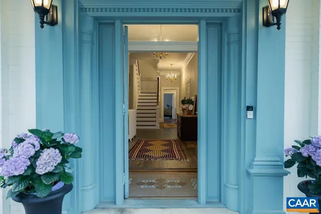 a view of a hallway to a livingroom with furniture