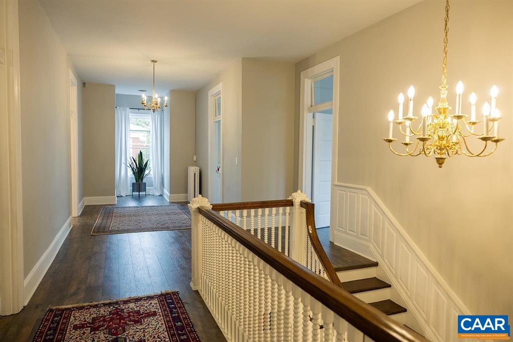409 Park Street Charlottesville, VA 22902 - Photo 56 of 58 a view of a hallway with wooden floor and staircase
