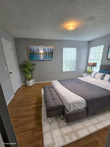 a bedroom with a bed and chandelier