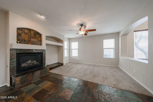 a kitchen with stainless steel appliances granite countertop a refrigerator a sink a stove and a refrigerator