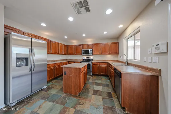 a kitchen with a sink stove and wooden cabinets