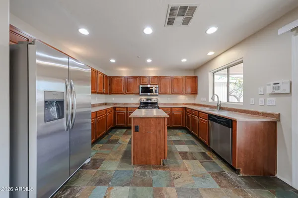 a kitchen with a sink stove top oven and microwave