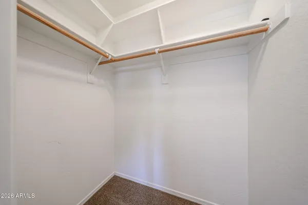 a bathroom with a double vanity sink a toilet and a mirror