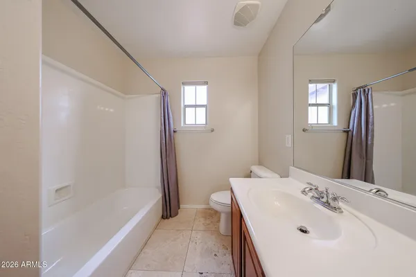 an empty room with fan and fan