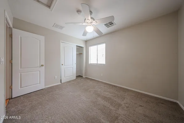 a view of an empty room with a ceiling fan
