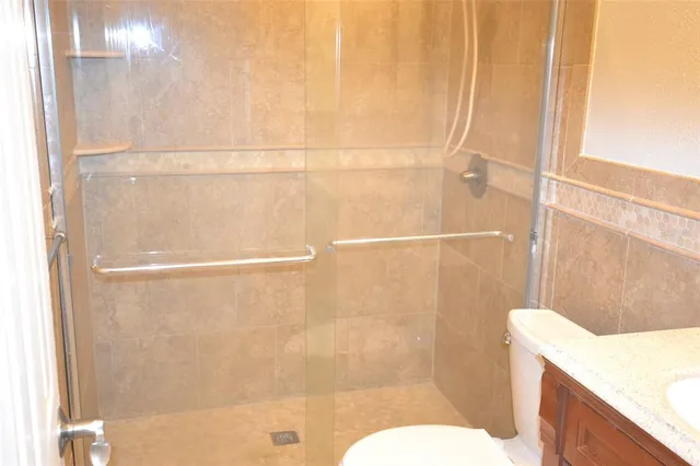 a bathroom with a shower and a toilet