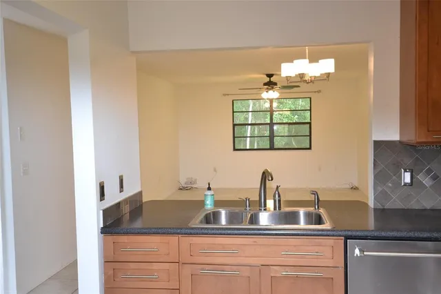 a kitchen with a sink and a mirror