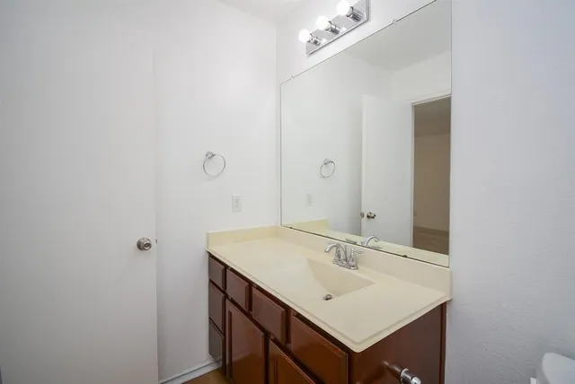 a bathroom with a sink vanity and a mirror