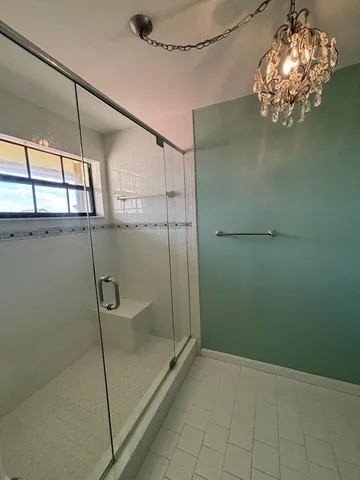 a bathroom with a glass shower door