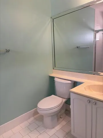 a bathroom with a toilet a sink and shower