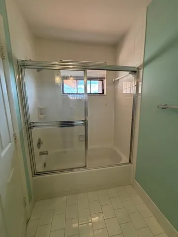 a bathroom with a glass shower door