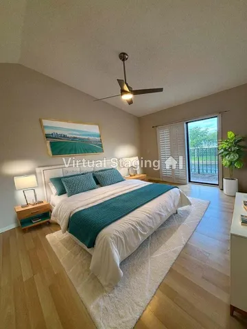 a bedroom with a large bed and a wooden floor