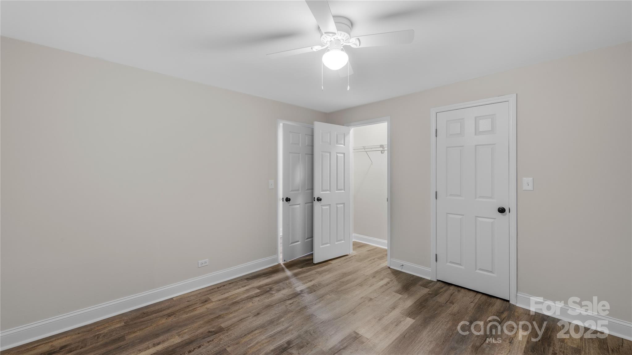7860 Henry Harris Road Fort Mill, SC 29707 - Photo 20 of 31 a view of an empty room with wooden floor