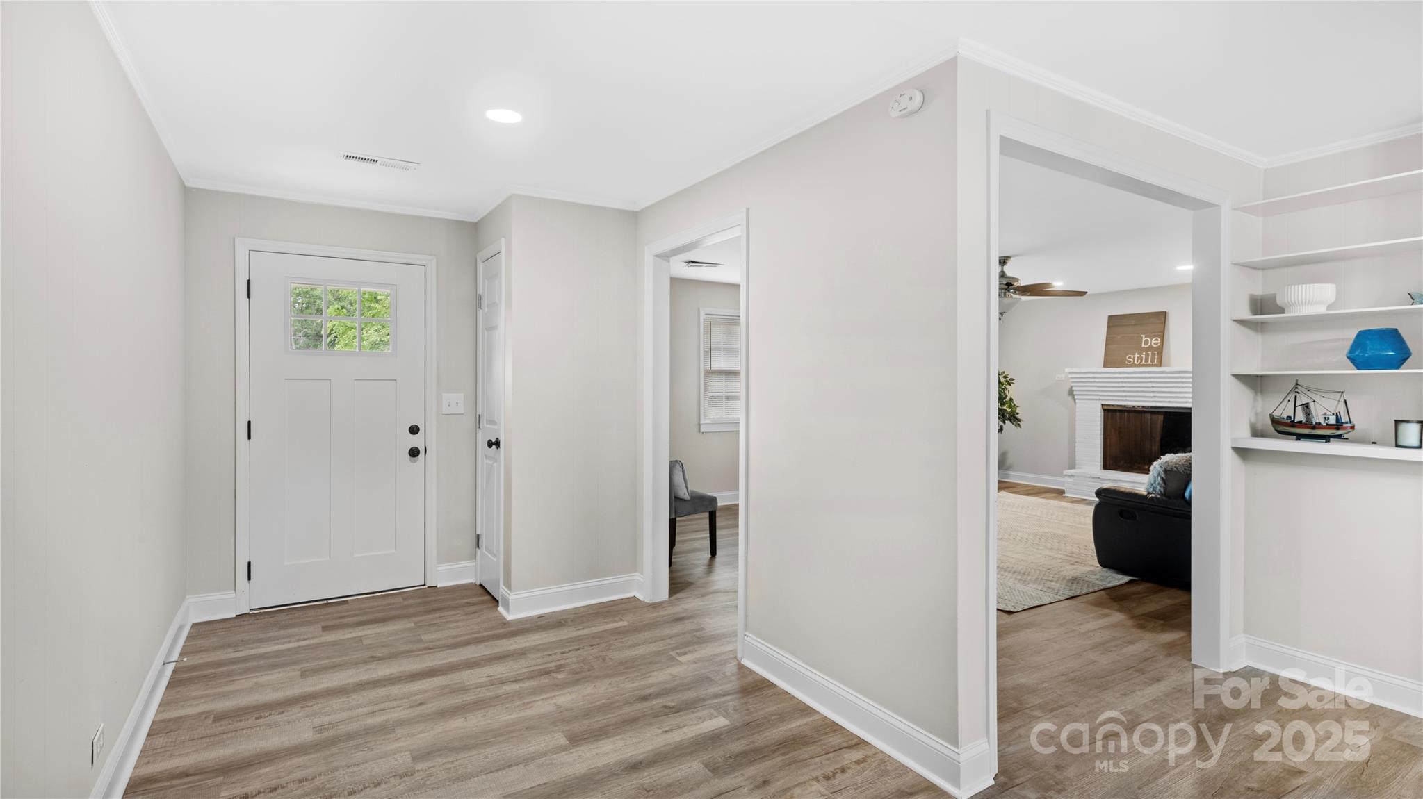7860 Henry Harris Road Fort Mill, SC 29707 - Photo 2 of 31 a view of a hallway with wooden floor and a living room
