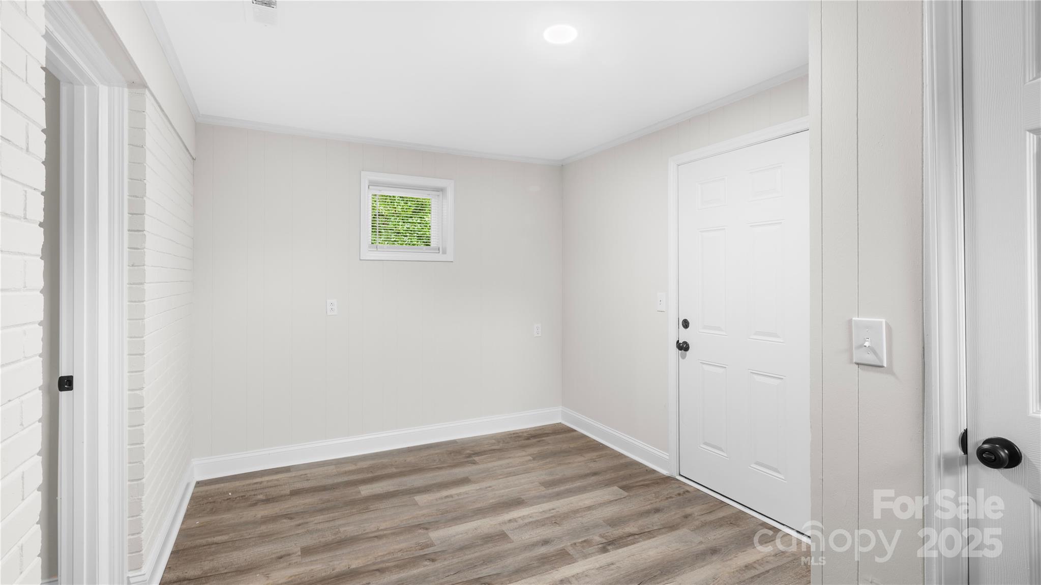 7860 Henry Harris Road Fort Mill, SC 29707 - Photo 23 of 31 a view of an empty room with wooden floor and a window