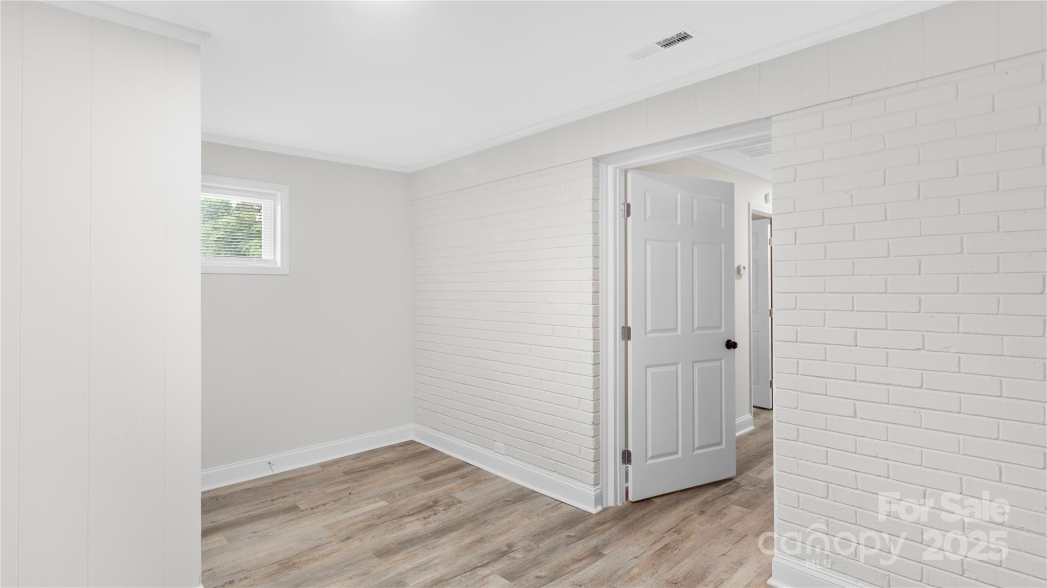 7860 Henry Harris Road Fort Mill, SC 29707 - Photo 24 of 31 a view of an empty room with wooden floor