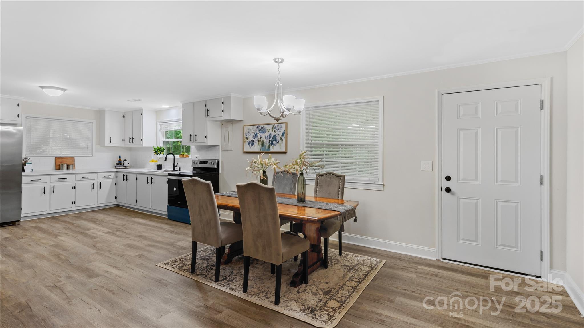 7860 Henry Harris Road Fort Mill, SC 29707 - Photo 3 of 31 a view of a dining room with furniture and wooden floor