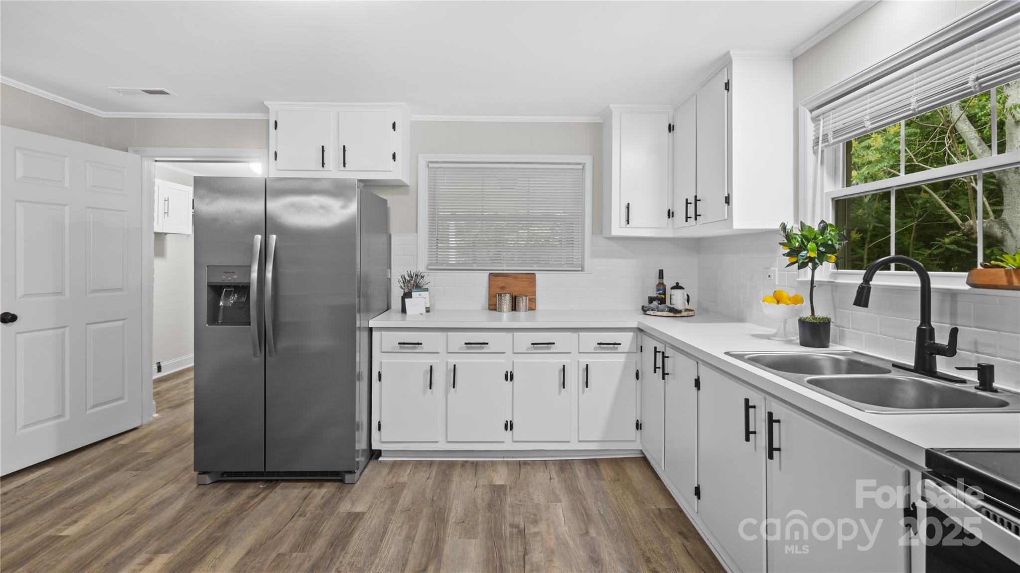 7860 Henry Harris Road Fort Mill, SC 29707 - Photo 7 of 31 a kitchen with a refrigerator sink and wooden floor