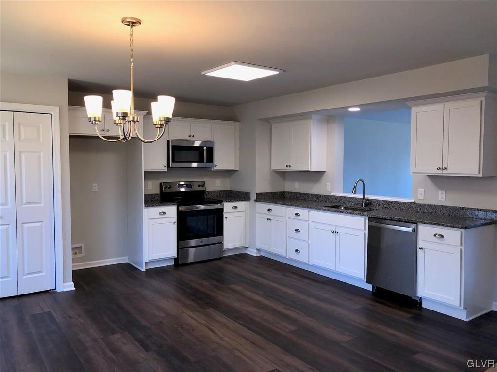 1604 Clauser Street Hellertown, PA 18055 - Photo 4 of 14 a kitchen with stainless steel appliances granite countertop a stove a sink and a microwave