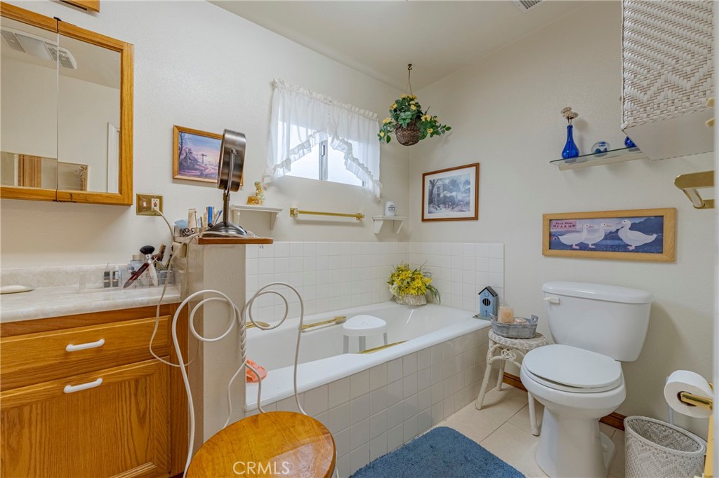 4263 Gurr Road Atwater, CA 95301 - Photo 40 of 73 a white toilet sitting next to a bathroom sink and tub