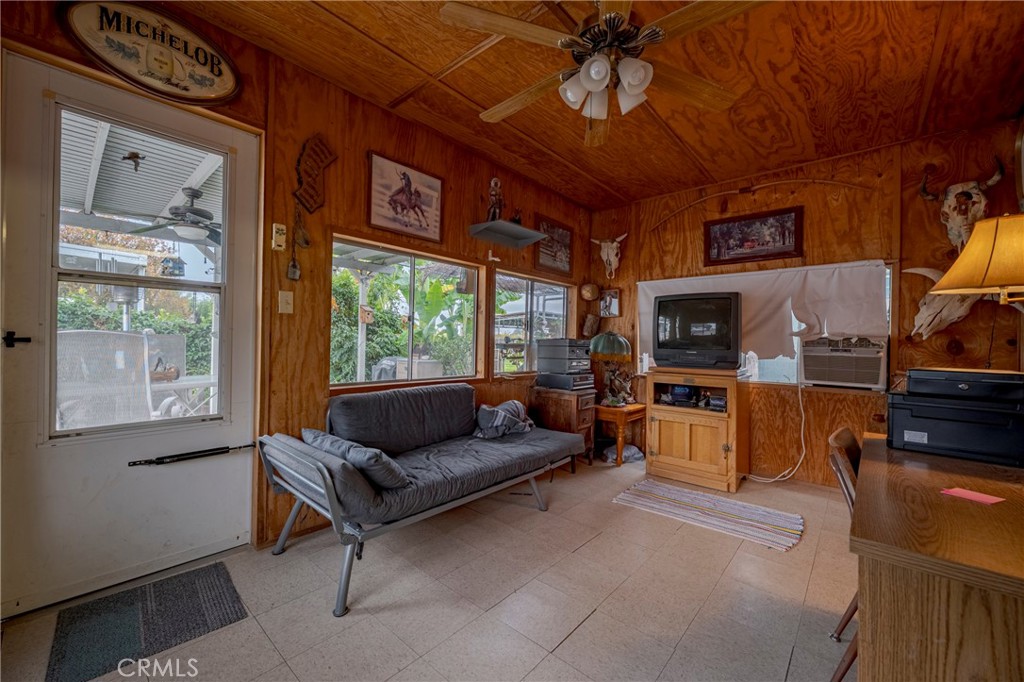 4263 Gurr Road Atwater, CA 95301 - Photo 55 of 73 a living room with furniture a flat screen tv and a floor to ceiling window