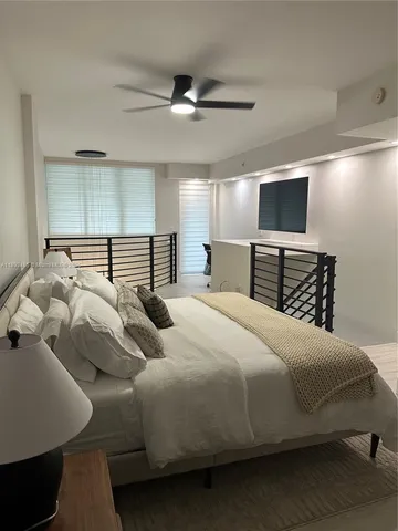 a bedroom with a bed and a television