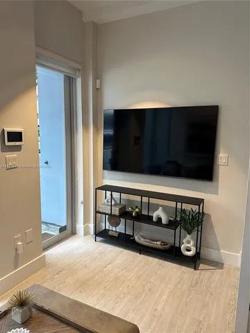 a view of bedroom with furniture and flat screen tv