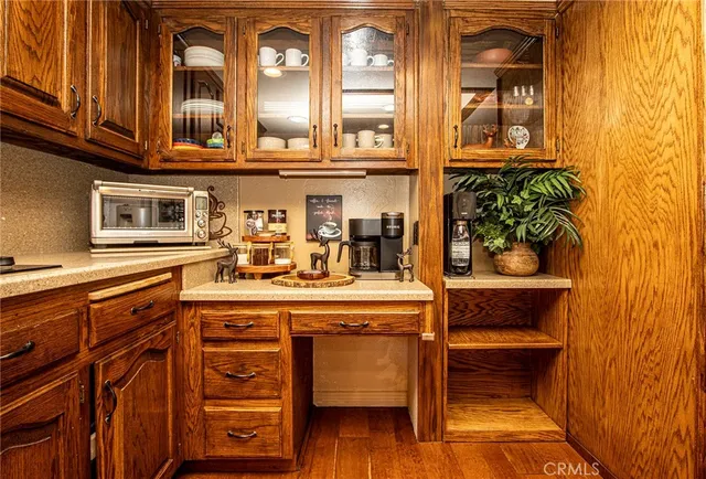 a kitchen with a sink appliances cabinets and a counter top space