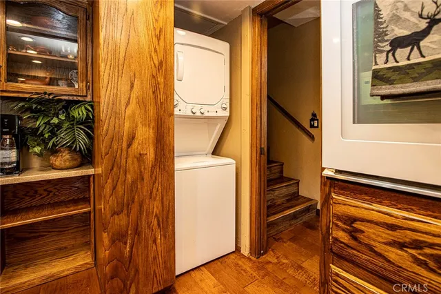 a dining room with furniture a chandelier and wooden floor