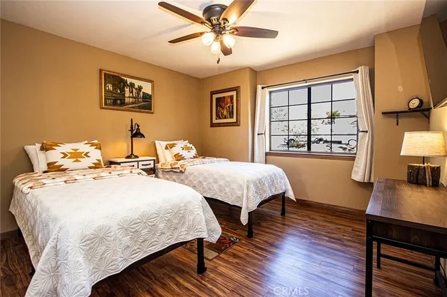 a bedroom with 2 bed and a chandelier