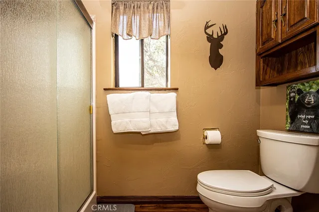 a white toilet sitting next to a bathroom sink