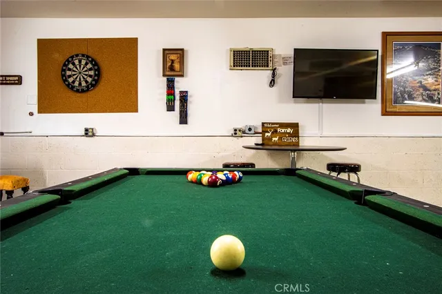 a dining room with furniture water view and a floor to ceiling window