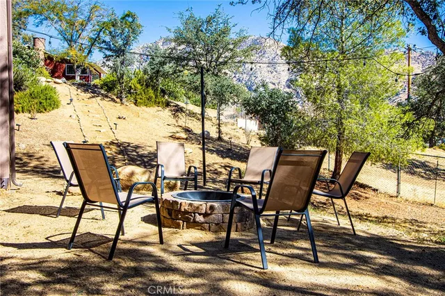 a view of a house with a yard and potted plants