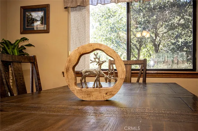 a dining room with furniture a chandelier and wooden floor